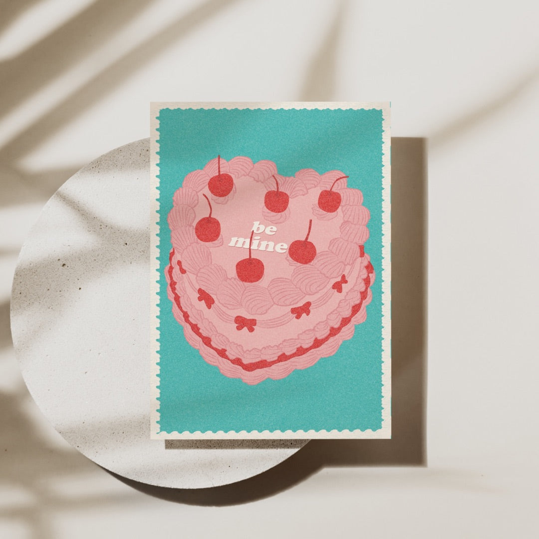 Peggy Press Co[product_name]This vintage-inspired Valentine's Day card features a whimsical illustration of a deliciously heart-shaped vintage cake, adorned with cherrie and retro typography. The pastel colours and playful design make this card perfect for sending sweet sentiments to your loved one! The card is made from high-quality paper, ensuring that your message will be cherished for years to come. The inside of the card is blank, allowing you to write your own personal message. Whether you